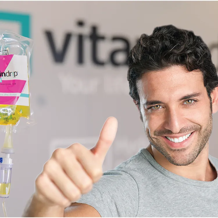 a man giving a thumbs up with a bag of liquid